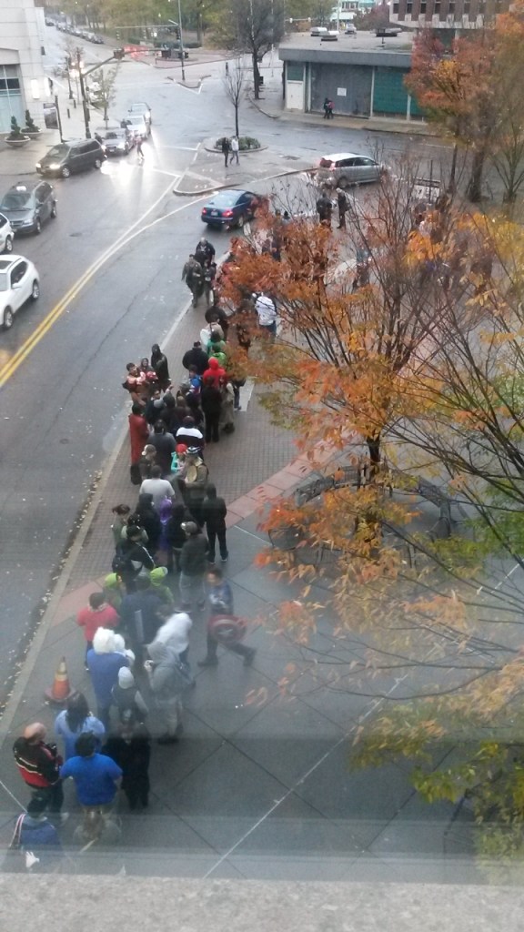 People standing in the freezing rain.